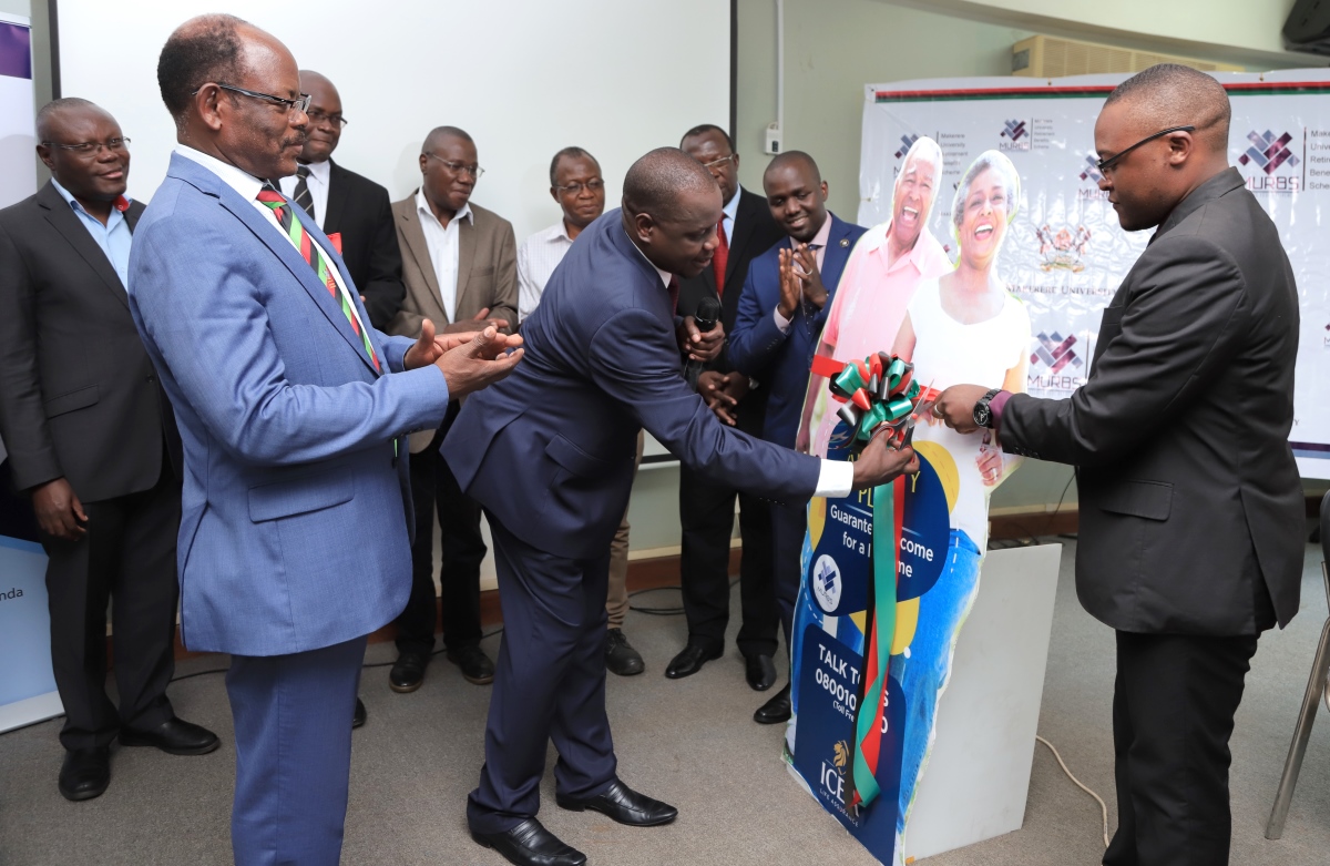 he-Vice-Chairperson-of-Council-Rt.-Hon.-Daniel-Fred-Kidega-cuts-the-tape-to-signify-the-official-launch-of-the-MURBS-Annuity-Arrangement-with-ICEA-Life-Company